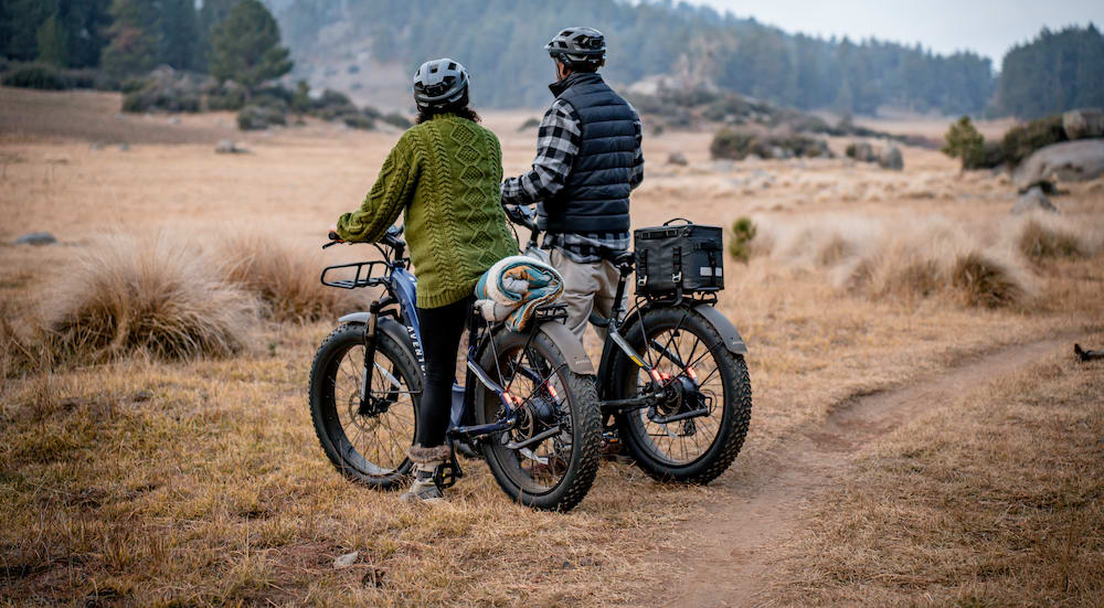 a man riding a motorcycle down a dirt road