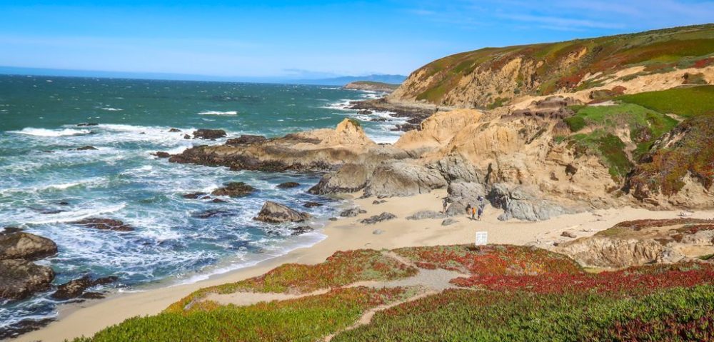 a rocky beach next to a body of water